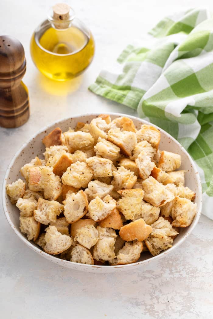 Large white bowl filled with homemade croutons.
