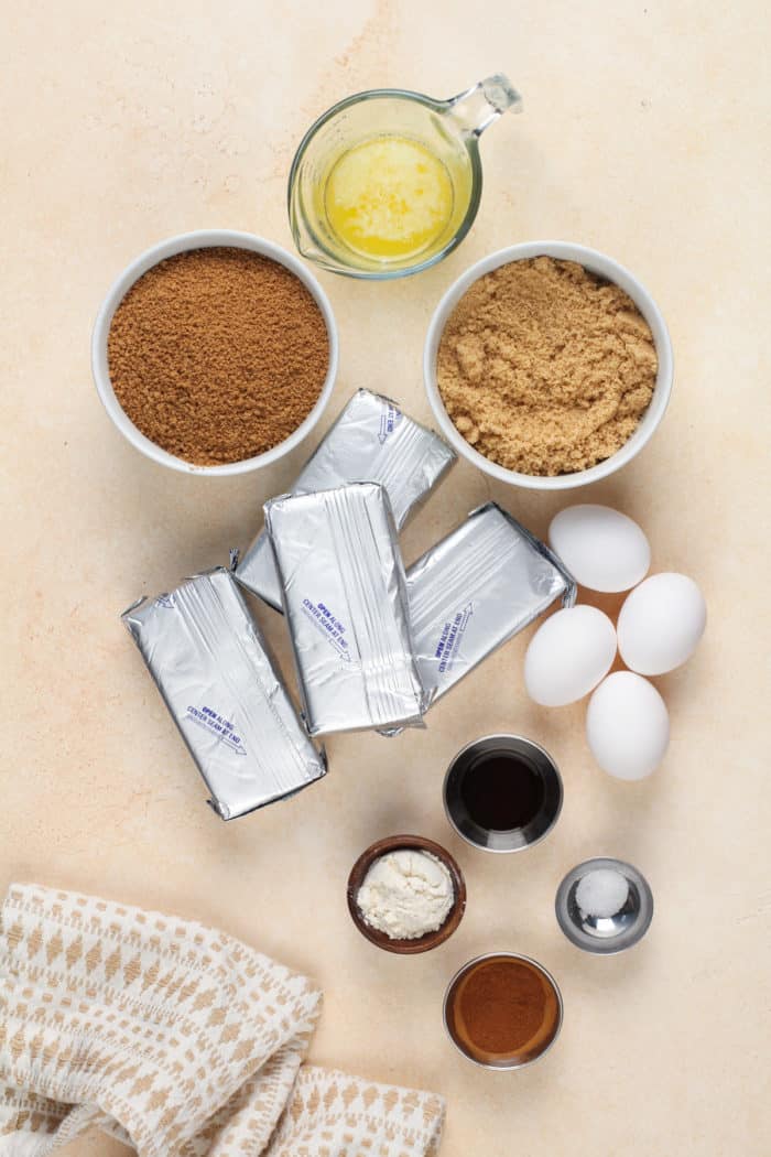 Ingredients for caramel apple cheesecake arranged on a countertop.