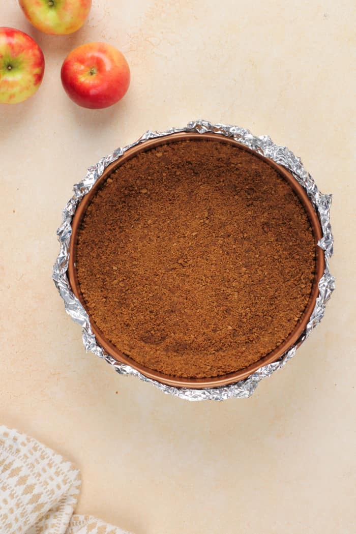 Gingersnap crust in a springform pan.