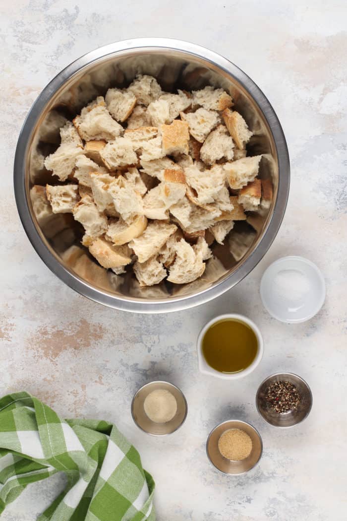 Ingredients for homemade croutons arranged on a countertop.