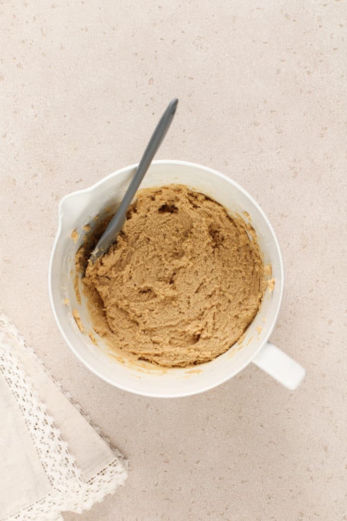 Maple cookie dough in a white mixing bowl.