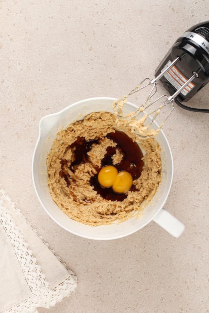 Wet ingredients for maple cookies in a white mixing bowl.