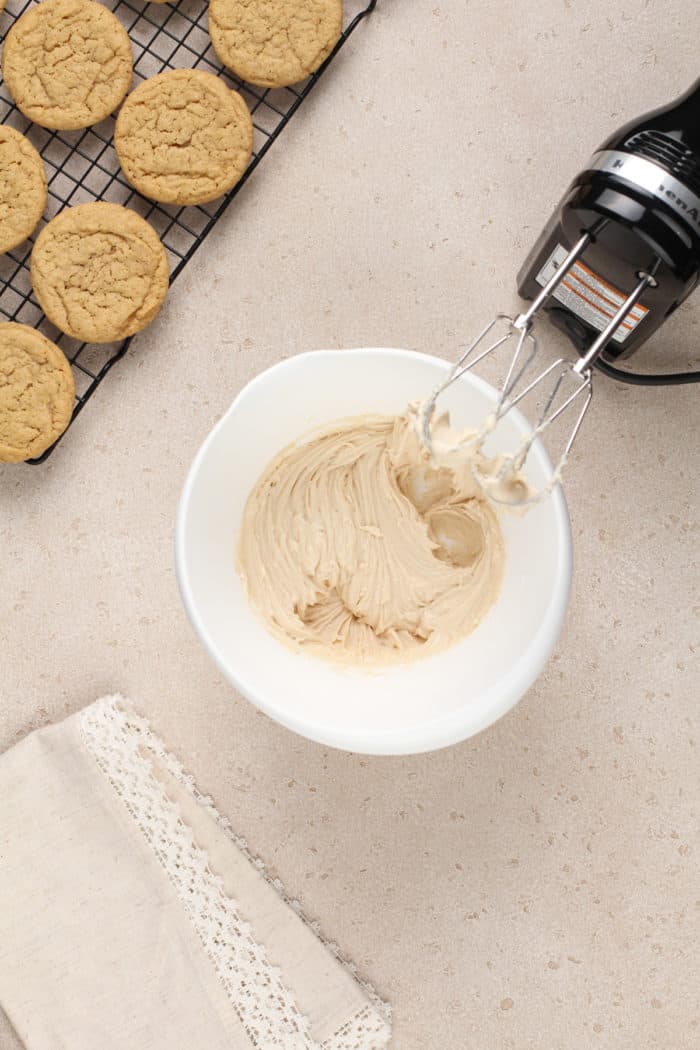 Maple frosting in a white mixing bowl.