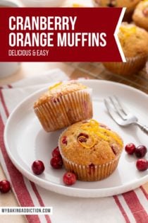 Two cranberry orange muffins on a white plate. Text overlay includes recipe name.