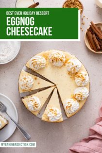 Overhead view of a sliced eggnog cheesecake garnished with whipped cream. Text overlay includes recipe name.