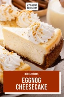 Cake server lifting a slice of eggnog cheesecake up from the whole cheesecake. Text overlay includes recipe name.