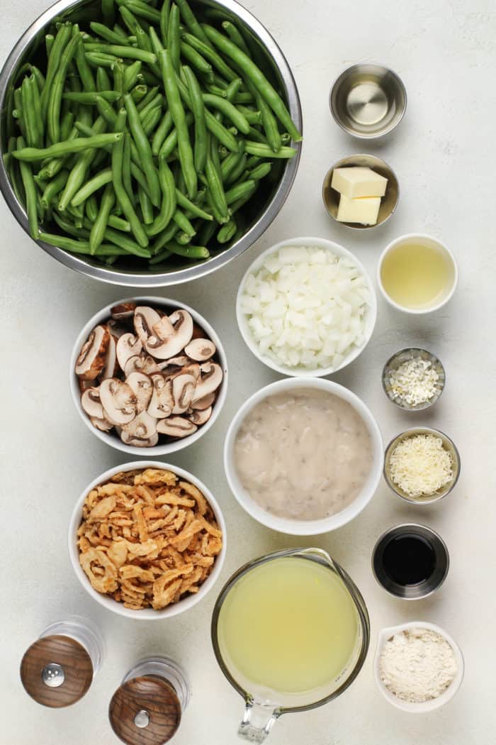 Fresh green bean casserole ingredients on a white countertop.
