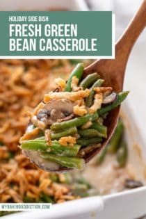 Wooden spoon holding up fresh green bean casserole to the camera, with the filled baking dish in the background. Text overlay includes recipe name.