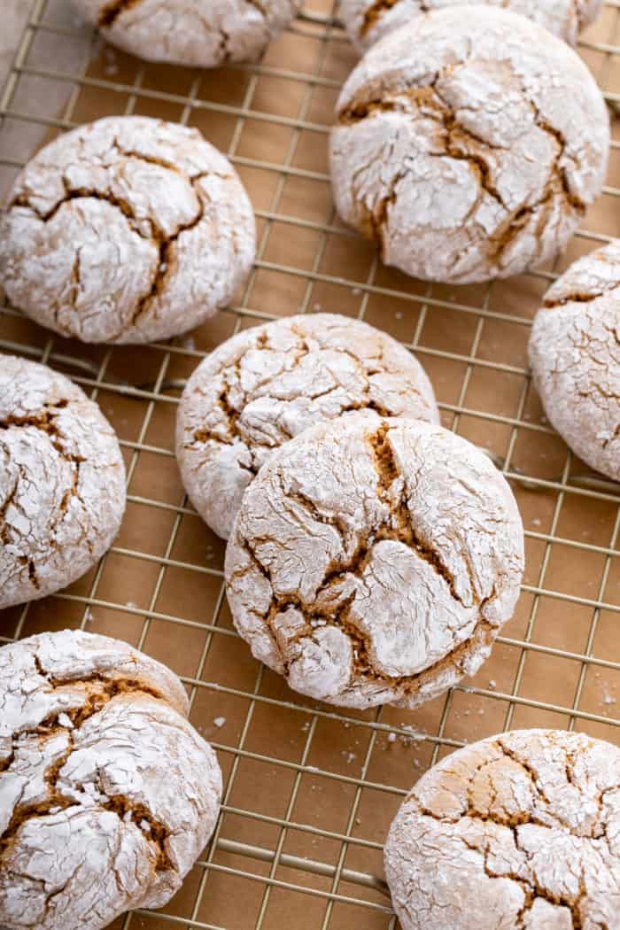 Close up of gingerbread crinkle cookies cooling on a wire rack.