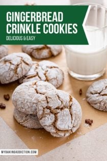 Gingerbread crinkle cookies scattered on a piece of parchment paper around a glass of milk. Text overlay includes recipe name.