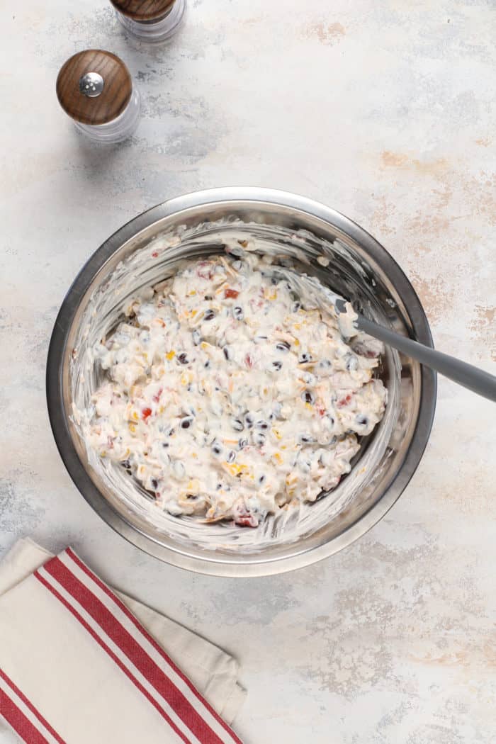 Fiesta ranch dip mixed in a metal mixing bowl.