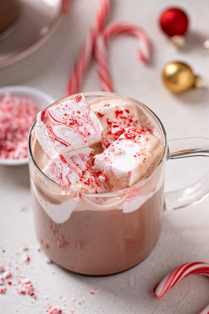 Close up view of peppermint marshmallows on top of a mug of hot chocolate.