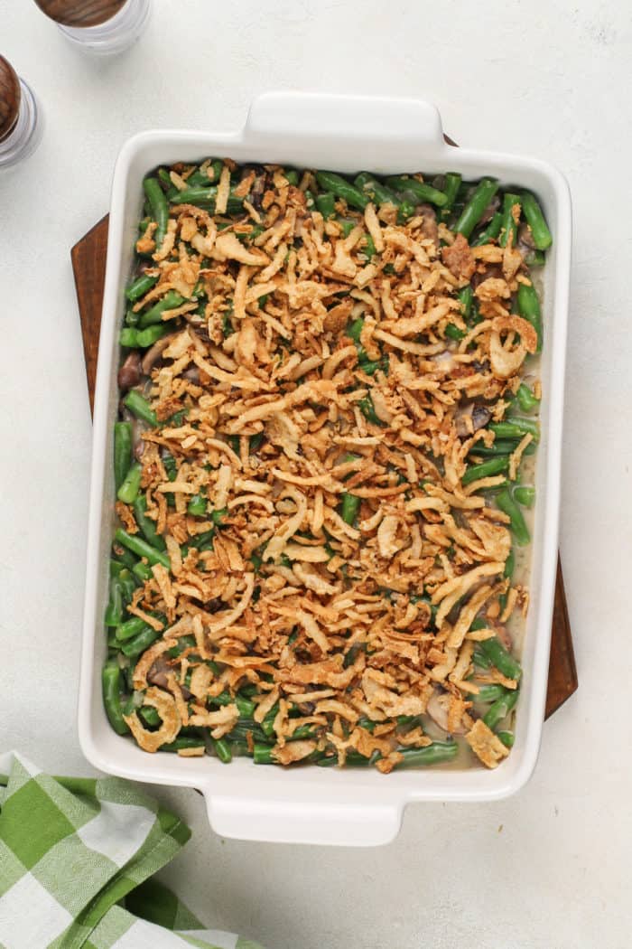 Unbaked fresh green bean casserole in a baking dish, ready to go in the oven.