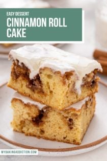 Two slices of glazed cinnamon roll cake stacked on a white plate. text overlay includes recipe name.