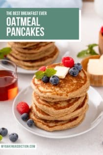 Two white plates, each holding a stack of oatmeal pancakes topped with fresh berries. Text overlay includes recipe name.