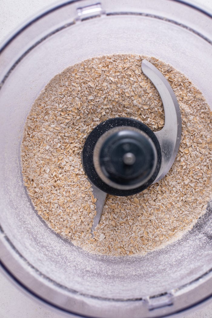 Oats being pulsed in a food processor.