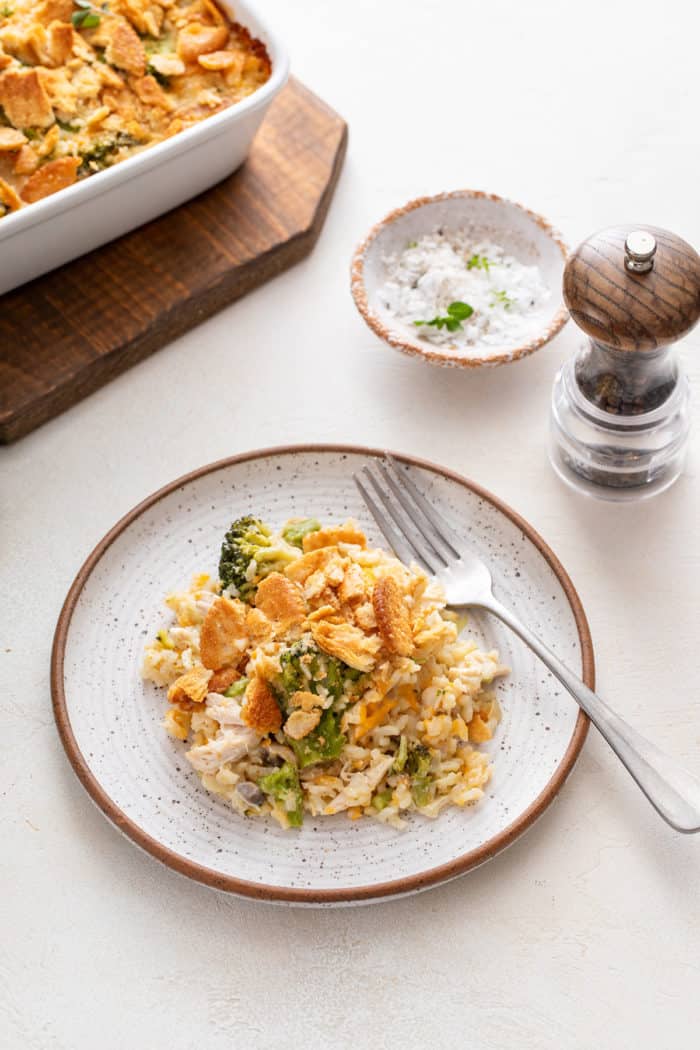 Stoneware plate filled with a serving of chicken broccoli rice casserole.