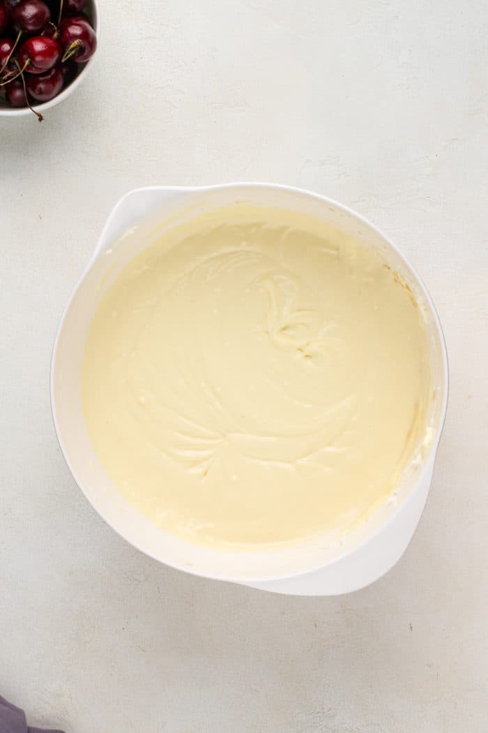 Base for cheesecake filling in a white bowl.