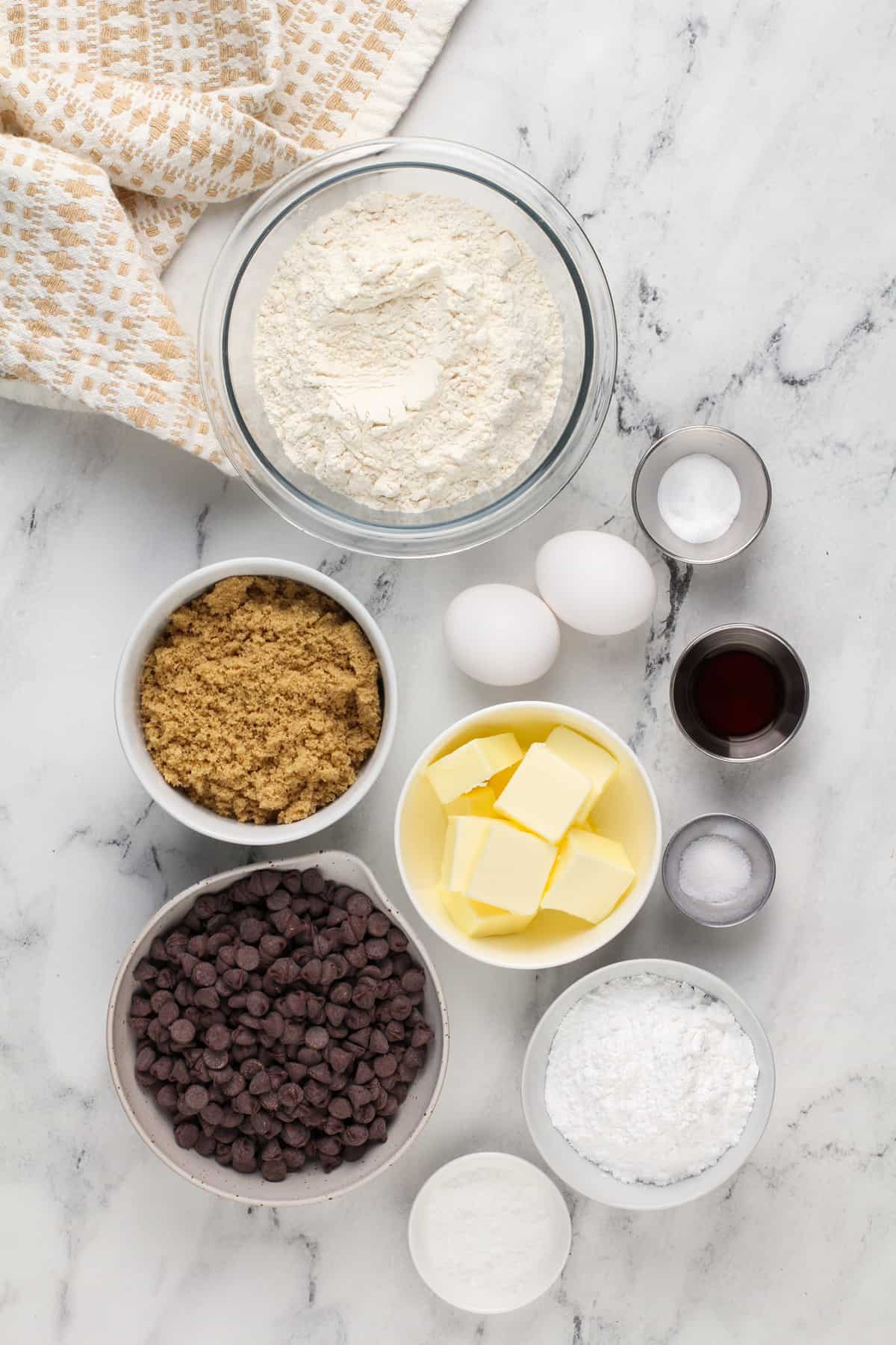 Ingredients for grand floridian chocolate chip cookies arranged on a marble countertop.