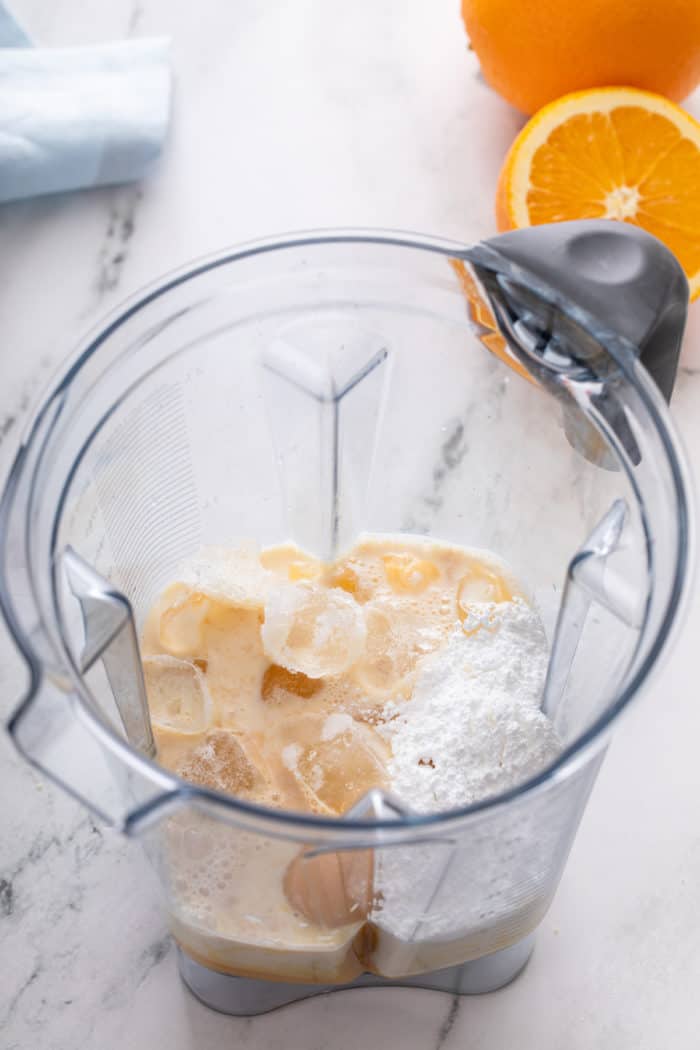 Ingredients for homemade orange julius in a blender.