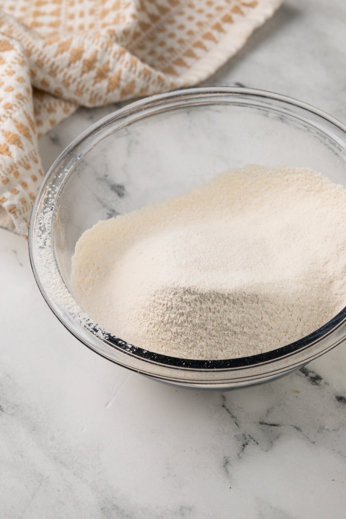 Dry ingredients for grand floridian chocolate chip cookies sifted together in a glass bowl.