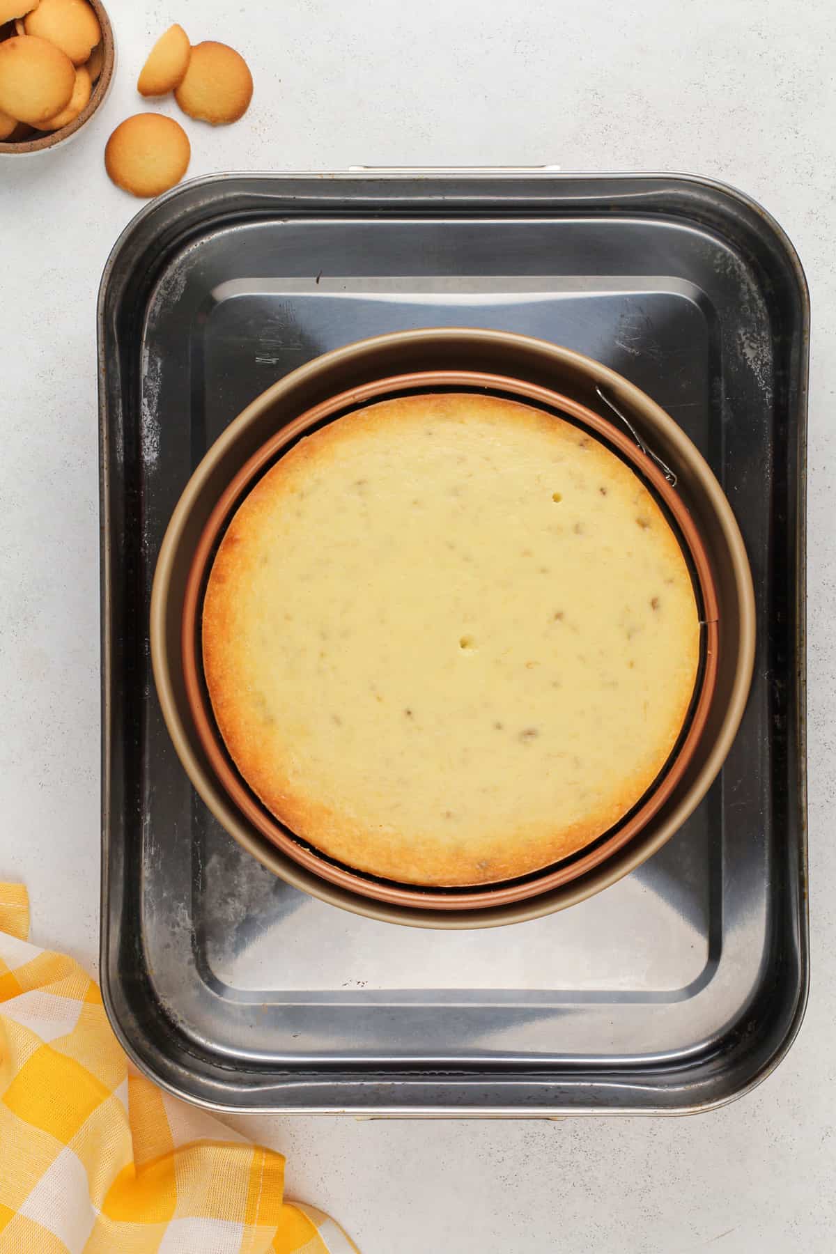 Baked banana pudding cheesecake in a roasting pan.