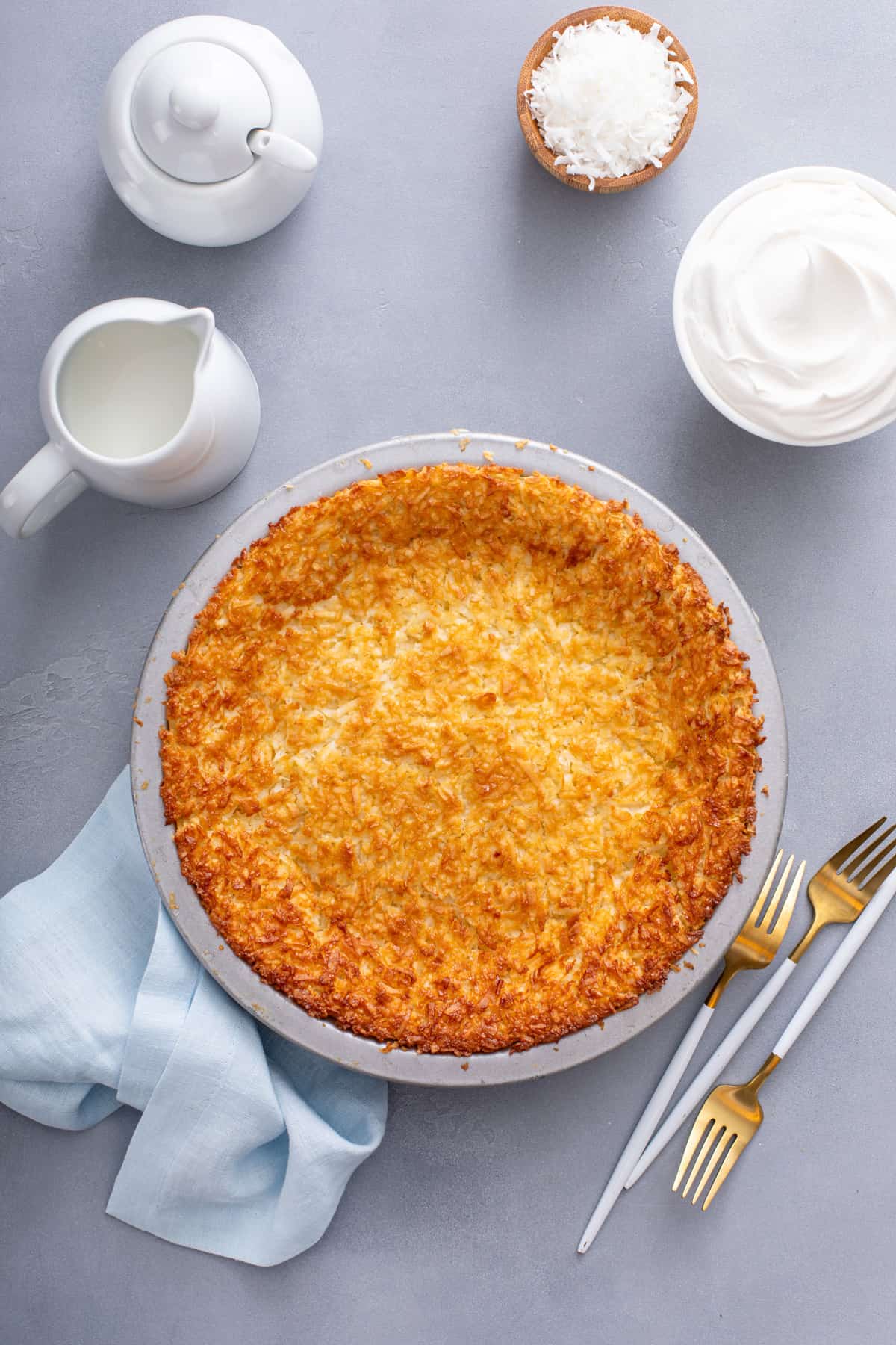 Overhead view of baked impossible coconut pie in a metal pie pan.