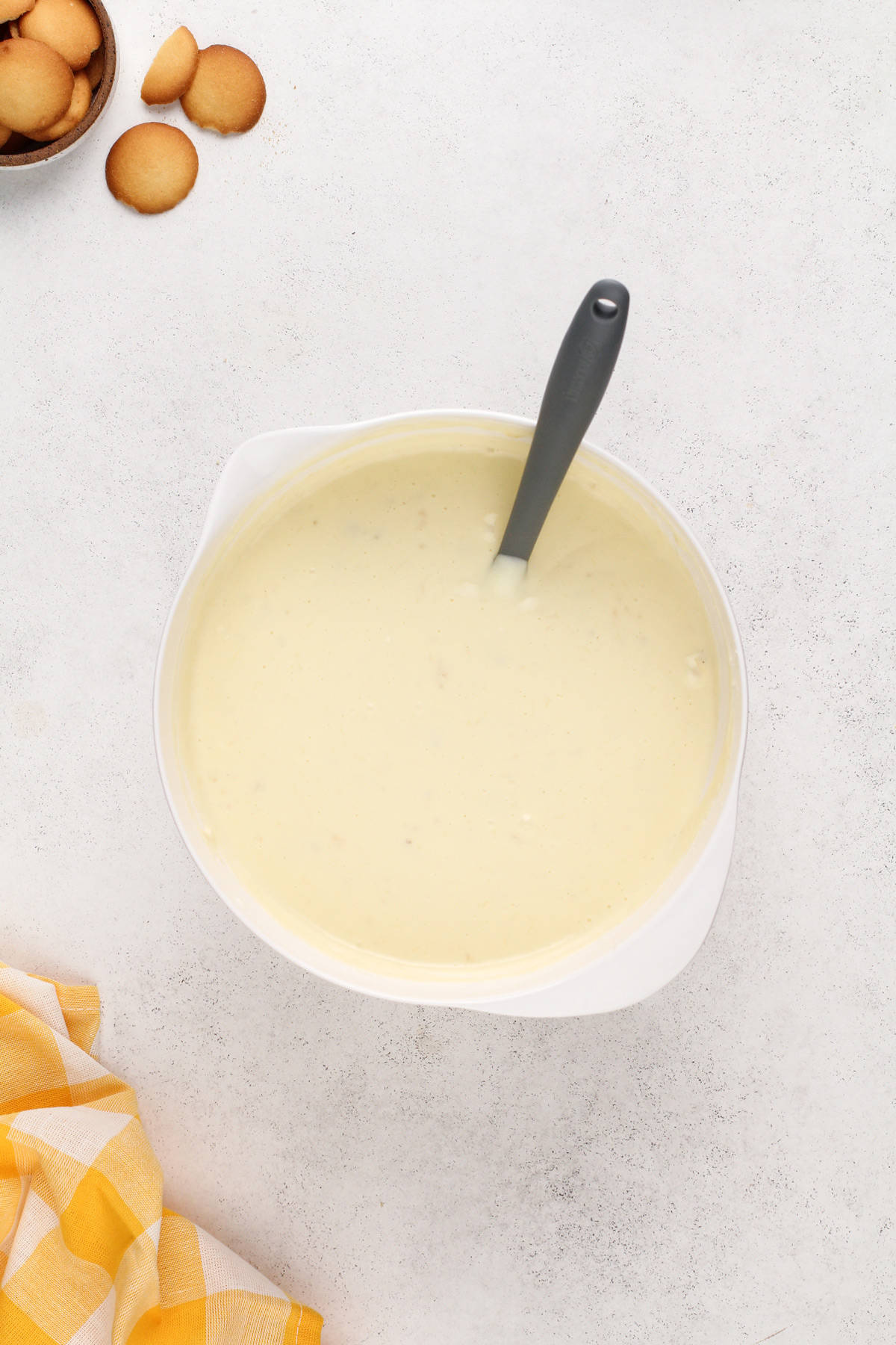 Banana pudding cheesecake filling in a white bowl.