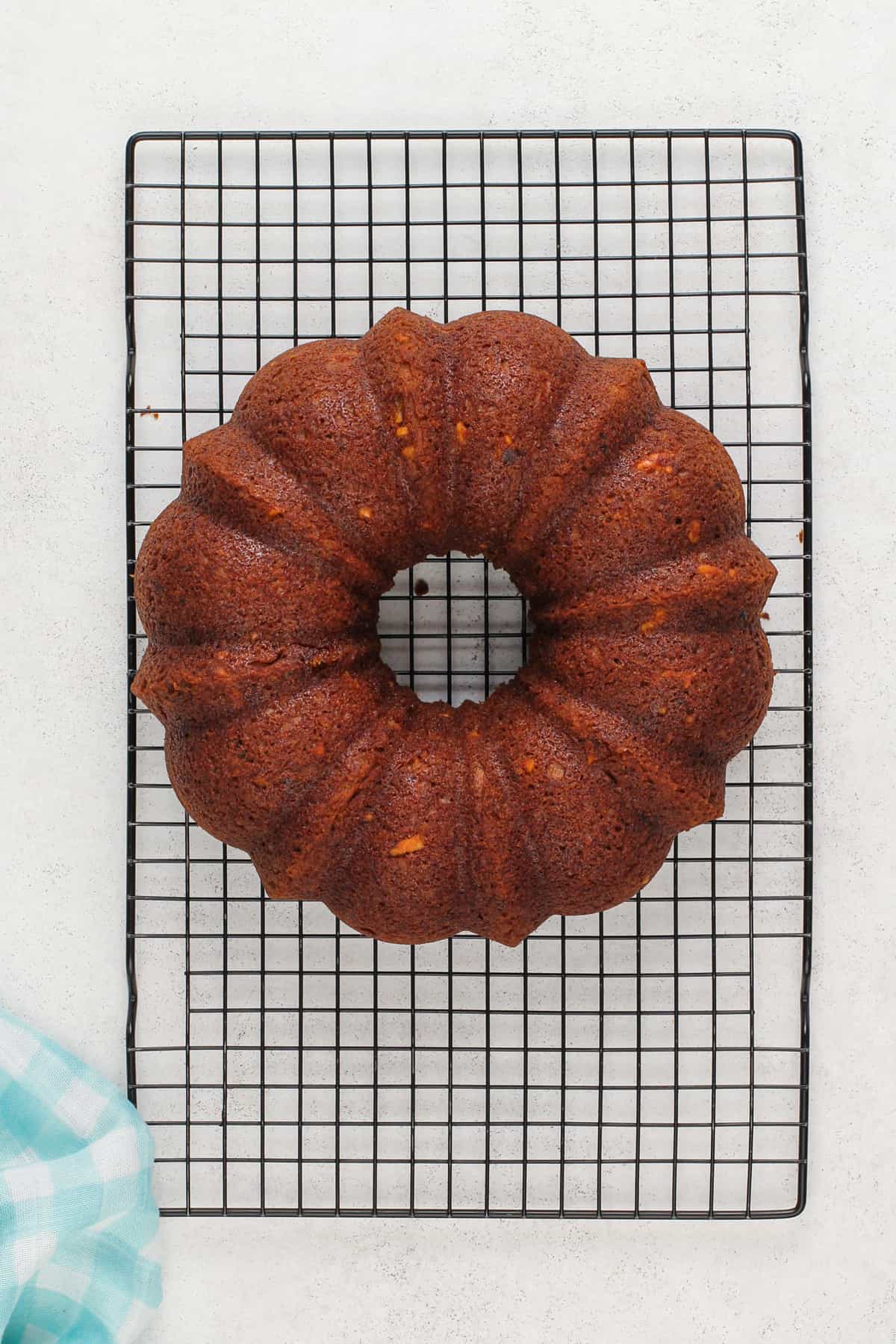 Carrot bundt cake cooling on a wire rack.