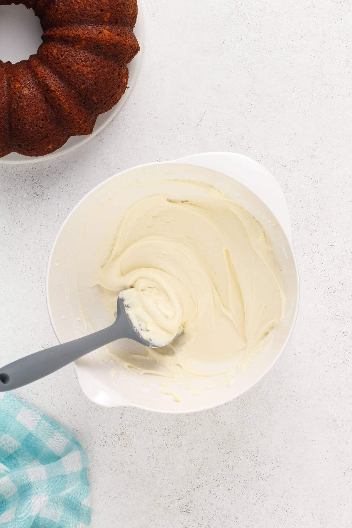 Cream cheese frosting in a white mixing bowl.