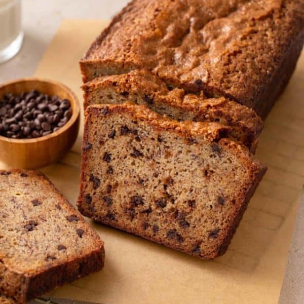 sliced loaf of chocolate chip banana bread on a piece of parchment paper.