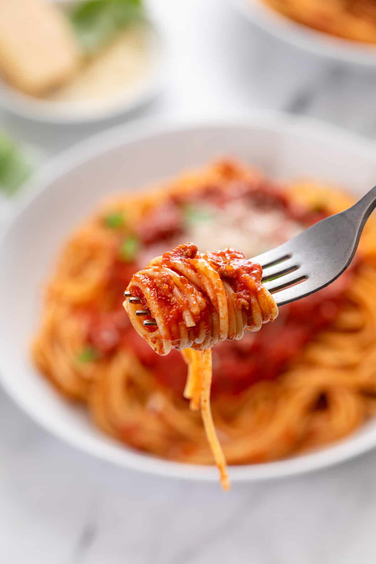 Fork holding up a bite of spaghetti.