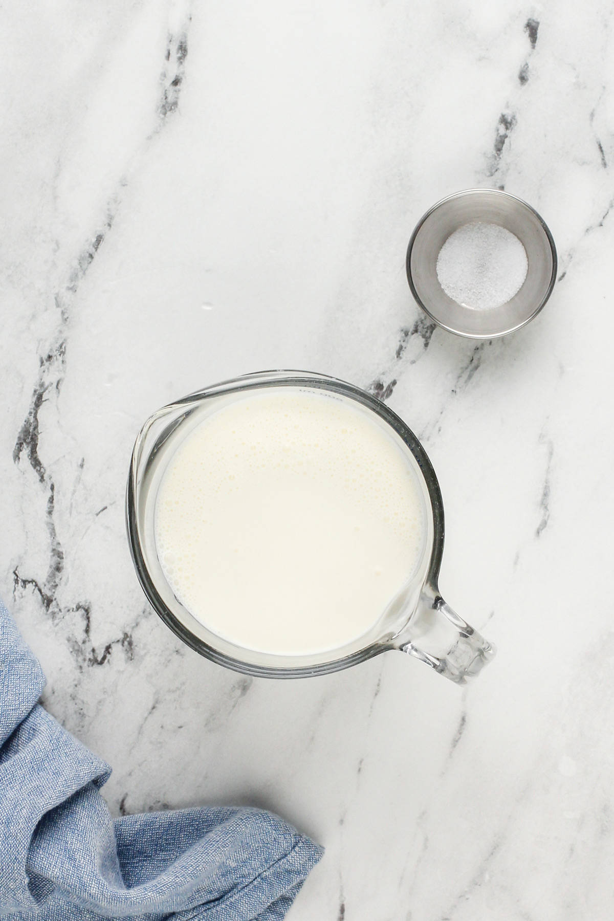 Homemade butter ingredients on a marble countertop.