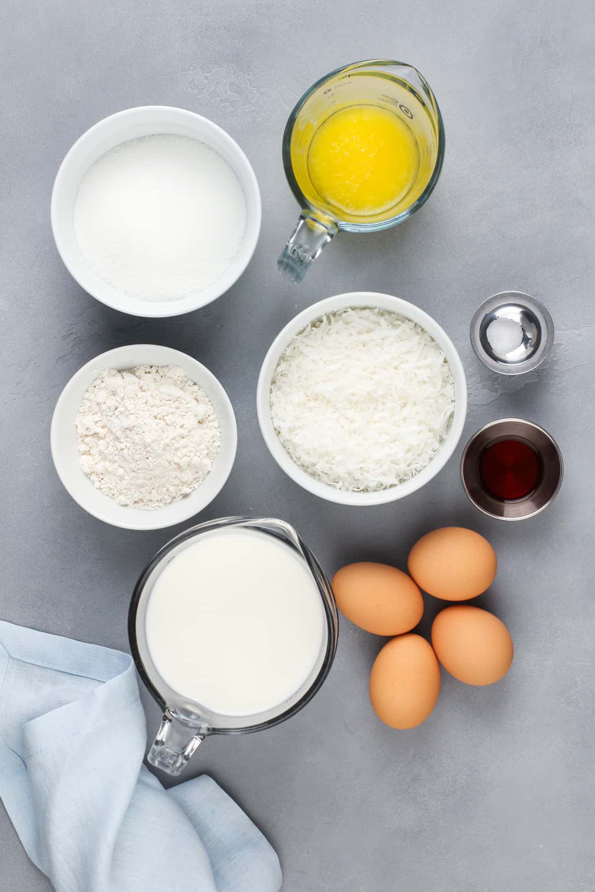 Ingredients for impossible coconut pie arranged on a gray countertop.