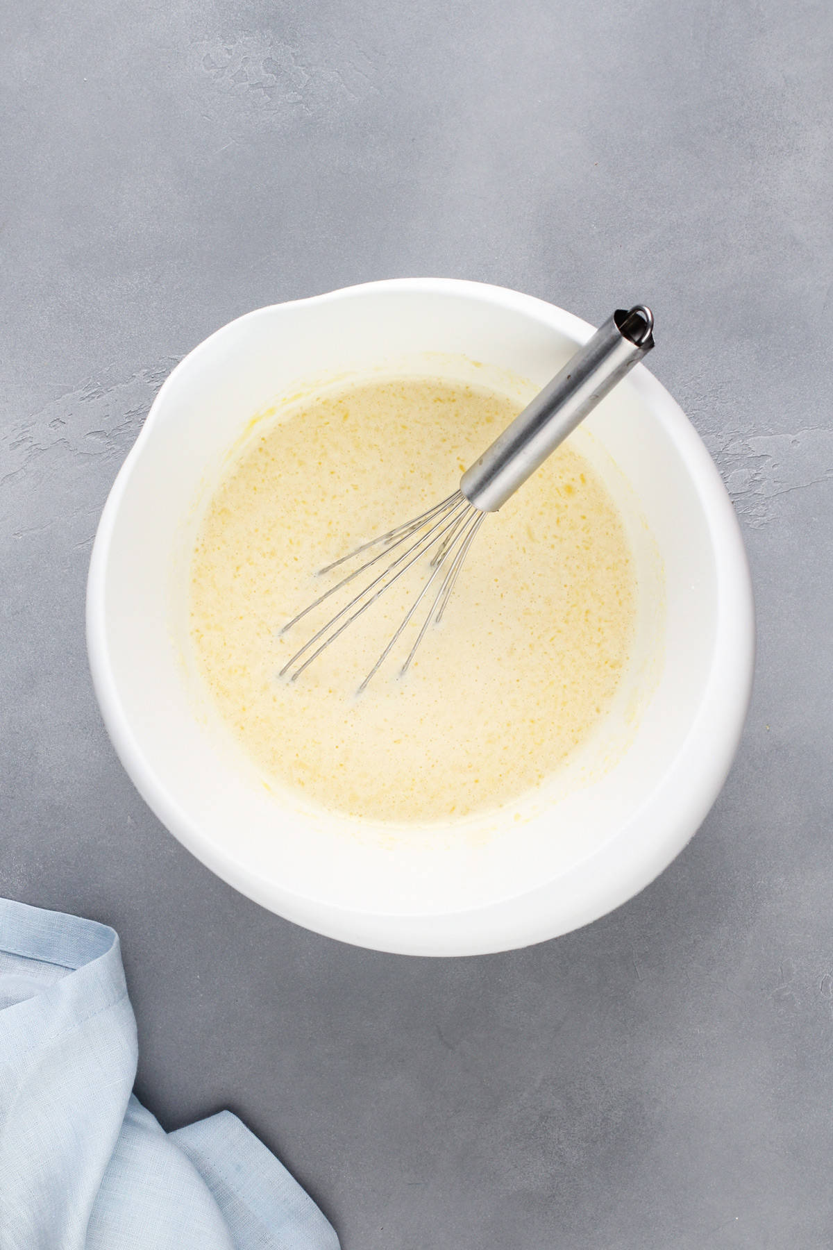 Impossible pie batter base whisked together in a white bowl.