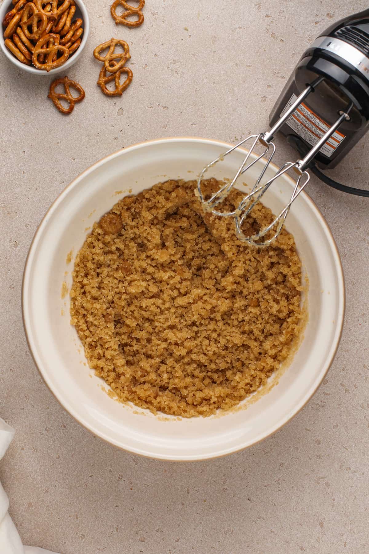 Brown butter and sugars mixed in a ceramic mixing bowl.