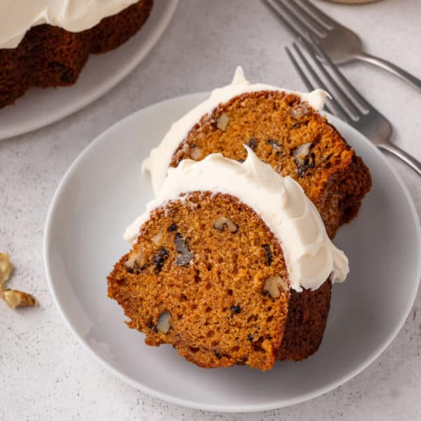 Two slices of carrot bundt cake on a plate.