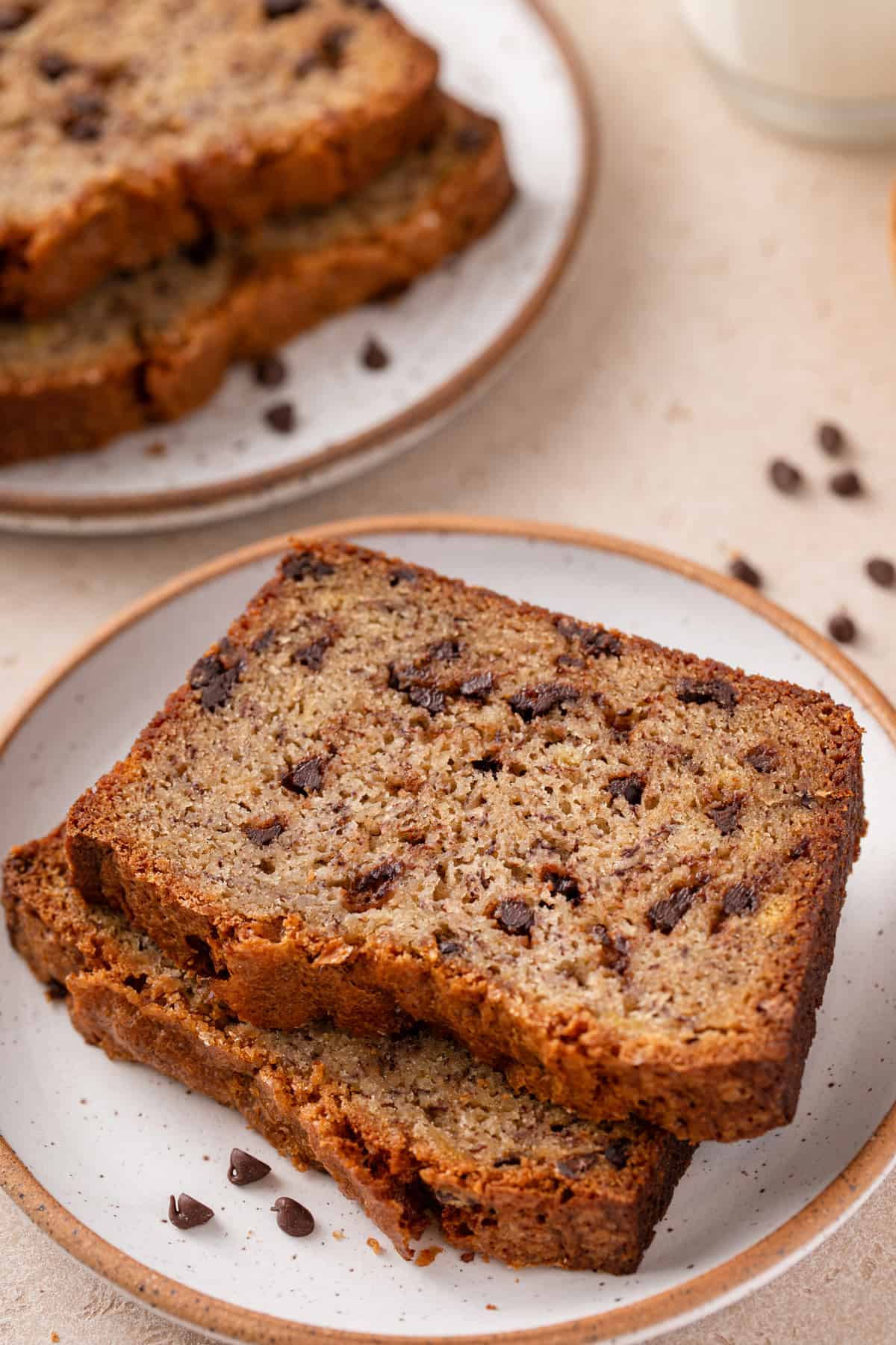 Two slices of chocolate chip banana bread on a plate.