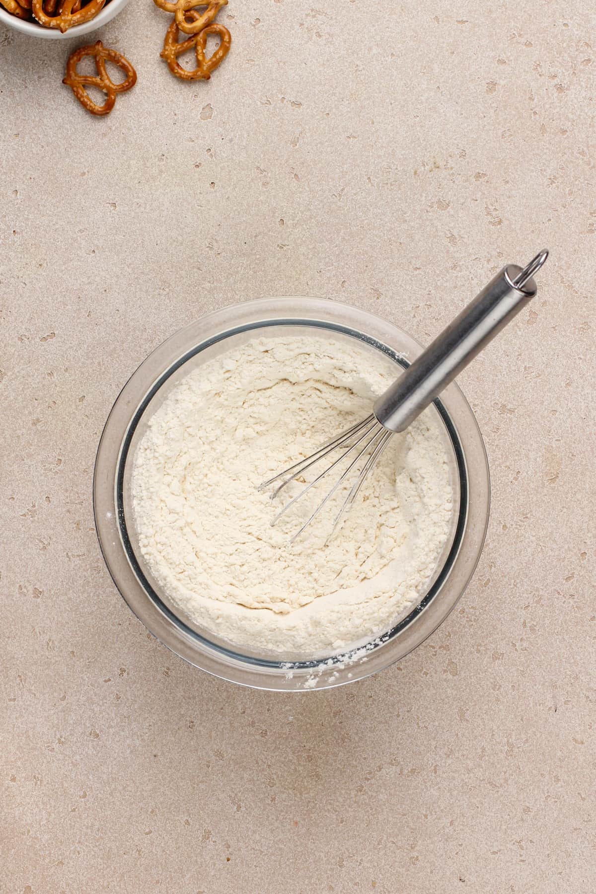 Dry ingredients for salted caramel pretzel cookies whisked together in a glass mixing bowl.