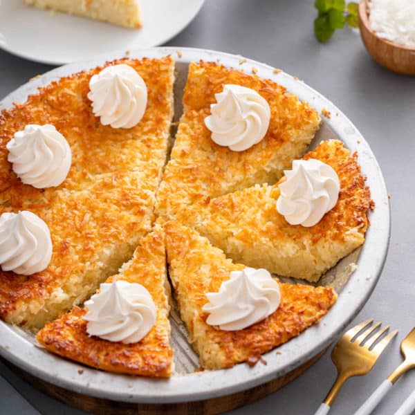 Sliced impossible coconut pie in a metal pie plate.