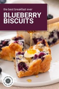Honey being drizzled over half of a blueberry biscuit on a white plate. Text overlay includes recipe name.