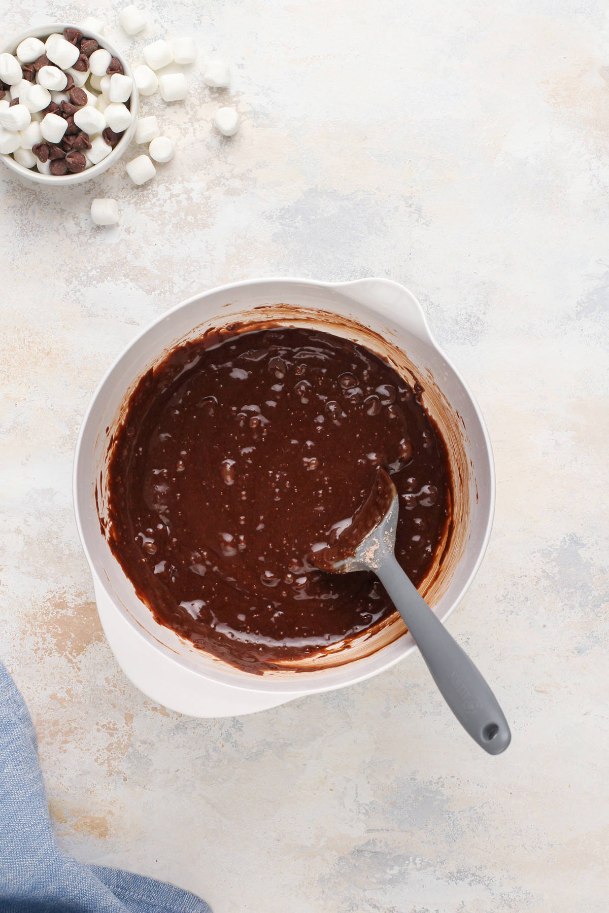 Brownie batter in a white mixing bowl.