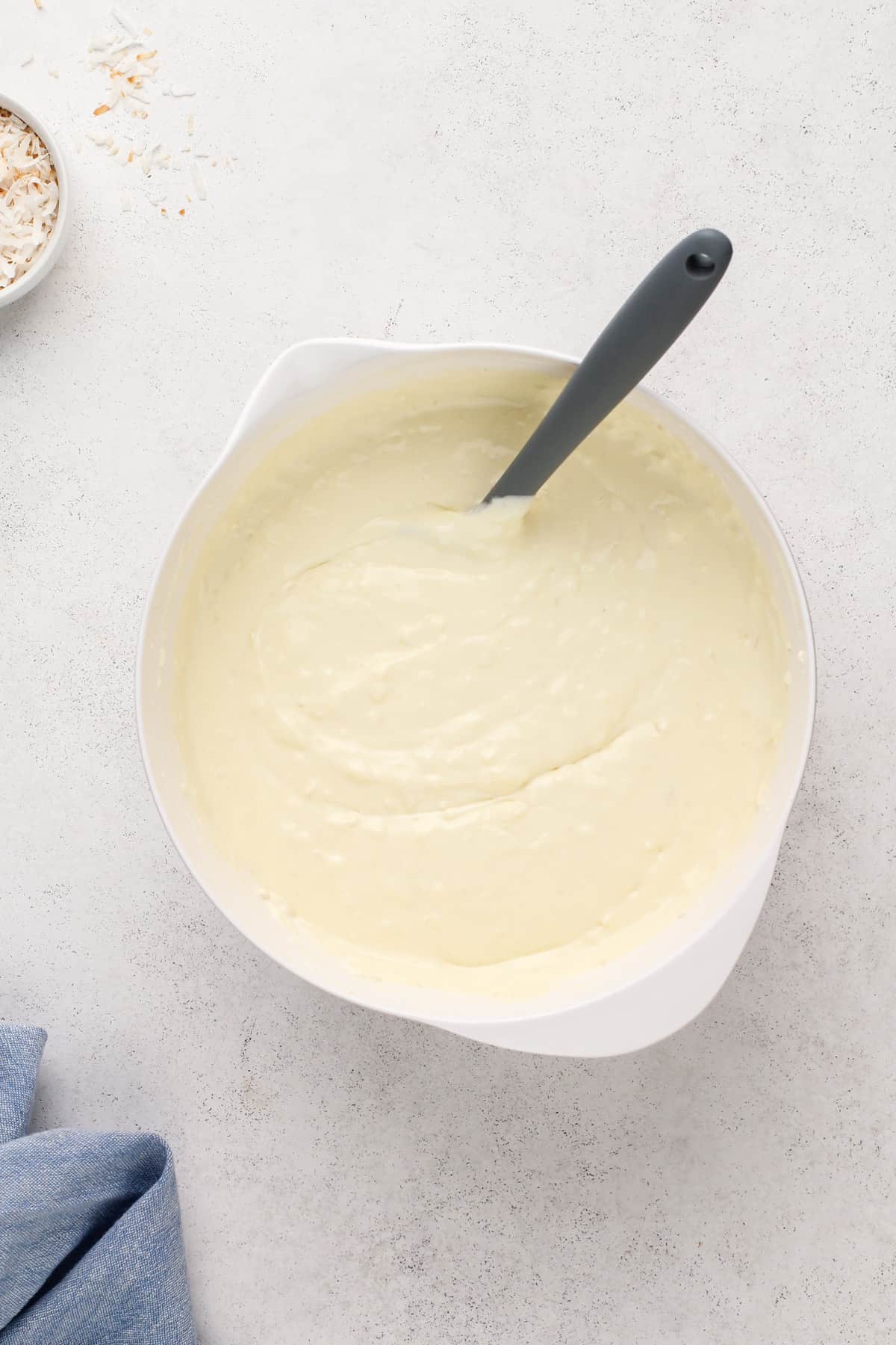 Eggs mixed into coconut cheesecake batter.