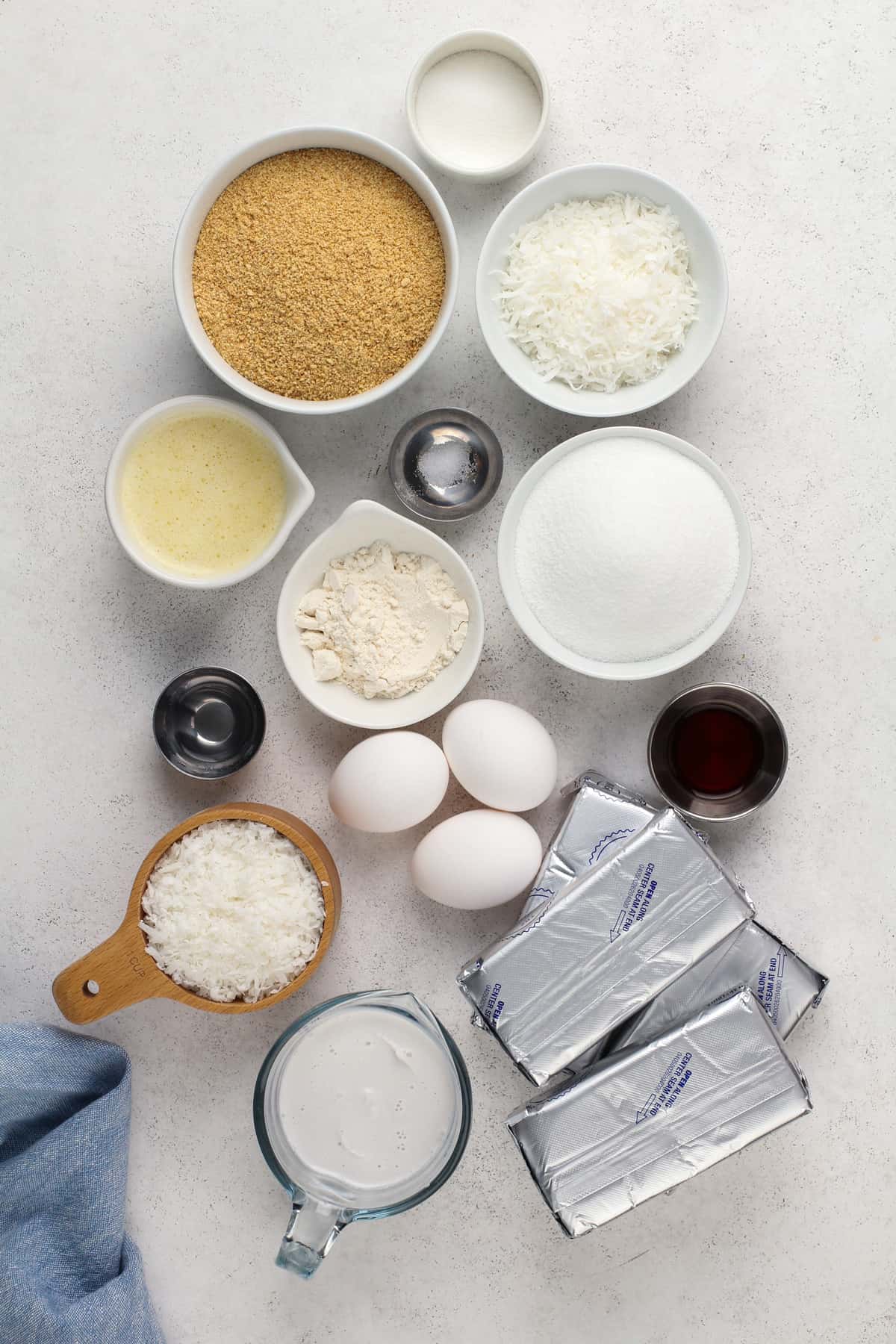 Coconut cheesecake ingredients arranged on a countertop.