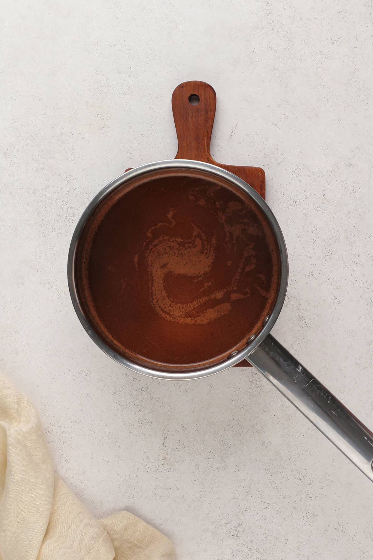 Cooked chocolate mixture for texas sheet cake in a saucepan.