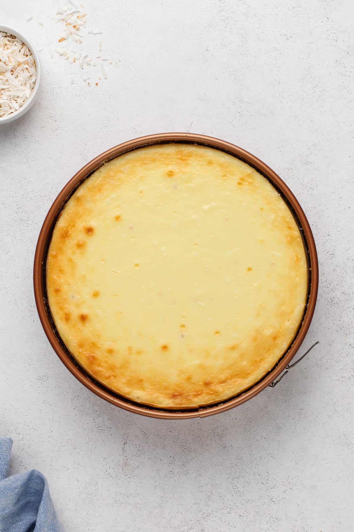 Baked and chilled coconut cheesecake in a springform pan.