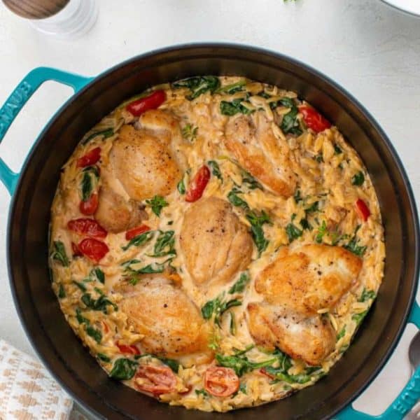 Overhead view of lemon chicken and orzo in a dutch oven.