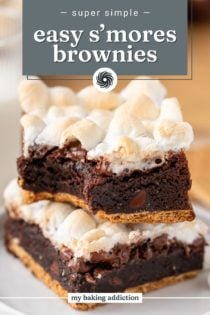 Two stacked easy s'mores brownies on a plate, with a bite taken from the corner of one brownie. Text overlay includes recipe name.