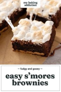 Easy s'mores brownie being pulled away from the rest of the sliced brownies on a piece of parchment paper. Text overlay includes recipe name.