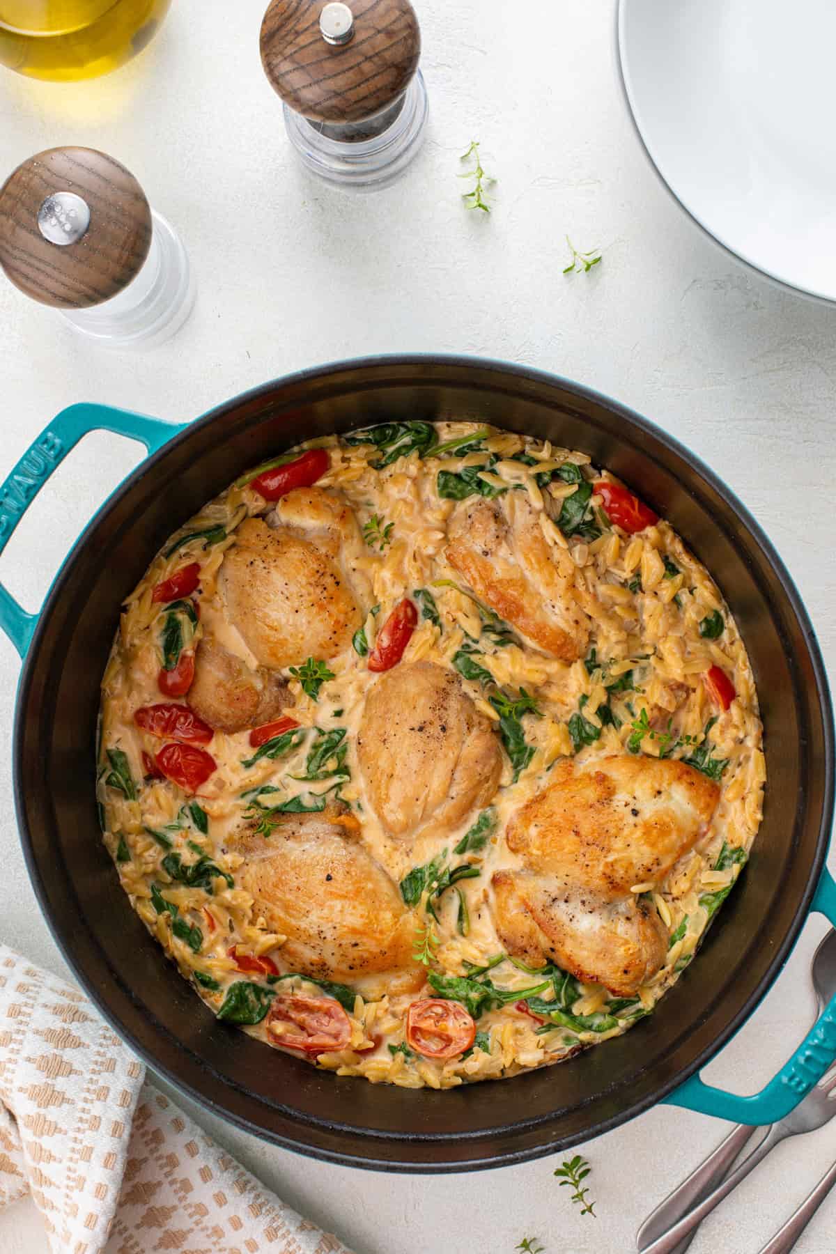 Overhead view of lemon chicken and orzo in a dutch oven.